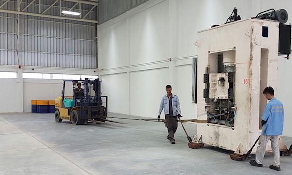 One of Redflow's four three-metre-high 16-tonne compression moulding presses being moved into position